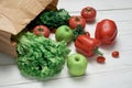 bag of fresh vegetables on a light wooden background . Royalty Free Stock Photo