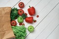 bag of fresh vegetables on a light wooden background . Royalty Free Stock Photo