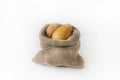 A bag of fresh white potatoes on a white isolated background. Harvest in autumn Royalty Free Stock Photo