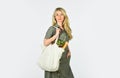 Bag with groceries. Reusable eco bag for shopping. Woman holding shopping bag with fruits and bread. Zero waste concept