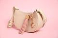 Bag with leather keychain on pink background, closeup Royalty Free Stock Photo