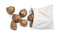 Bag and many Jerusalem artichokes isolated on white, top view Royalty Free Stock Photo