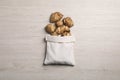 Bag with many Jerusalem artichokes on white wooden table, flat lay Royalty Free Stock Photo