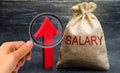 A bag with money and the inscription Salary and up arrow. increase of salary, wage rates. promotion, career growth. raising the Royalty Free Stock Photo