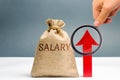 A bag with money and the inscription Salary and up arrow. increase of salary, wage rates. promotion, career growth. raising the Royalty Free Stock Photo