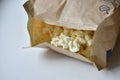 A bag of popcorn open on a plate in the kitchen Royalty Free Stock Photo