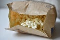 A bag of popcorn open on a plate in the kitchen Royalty Free Stock Photo