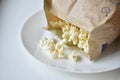 A bag of popcorn open on a plate in the kitchen Royalty Free Stock Photo