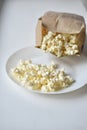 A bag of popcorn open on a plate in the kitchen Royalty Free Stock Photo