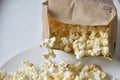 A bag of popcorn open on a plate in the kitchen Royalty Free Stock Photo