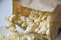 A bag of popcorn open on a plate in the kitchen Royalty Free Stock Photo