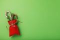 Bag of red color with Christmas gifts on a green background Royalty Free Stock Photo