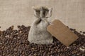 Bag from a sacking and a piece of string, on the coffee beans Royalty Free Stock Photo