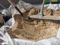 Bag of sand, shovel and helmet, break work on site construction