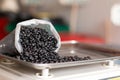 Bag of spilled black beans. Black beans on digital scale. Details of black beans. Ceco bean trade. Royalty Free Stock Photo