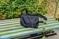 Bag on wooden bench at a railroad station at countryside Royalty Free Stock Photo