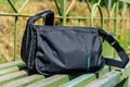 Bag on wooden bench at a railroad station at countryside Royalty Free Stock Photo