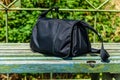 Bag on wooden bench at a railroad station at countryside Royalty Free Stock Photo