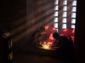 Young Buddhist praying with candles in pagoda