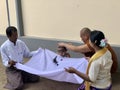 Bagan, Myanmar - 2019: Boy getting his hair shaved in the traditional Shinbyu, buddhist novitiation ceremony