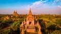 Bagan Myanmar, couple of men and woman looking at the sunrise on top of an old pagoda temple