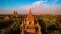 Bagan Myanmar, couple of men and woman looking at the sunrise on top of an old pagoda temple