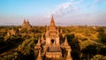 Bagan Myanmar, couple of men and woman looking at the sunrise on top of an old pagoda temple