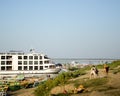 Bagan, Myanmar -A cruise ship and small boats anchored on the Irrawaddy River. Two dogs walking along the river. Royalty Free Stock Photo