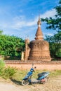 BAGAN, MYANMAR - DECEMBER 9, 2016: E-bike (electric scooter) in front of a stupa in Bagan, Myanm