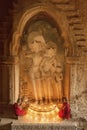 BAGAN, MYANMAR - FEB 20, 2015: Southeast Asian young little Buddhist monks praying with candle light in a Buddihist temple on FEB