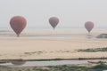 Bagan, Myanmar - March 2019: hot air balloons landing near Irrawaddy river