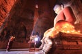 BAGAN, MYANMAR - May 2016: Monk burning candles in front of Buddha statue inside pagoda on May, 2016 in Bagan.