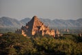 BAGAN, MYANMAR - NOVEMBER 18, 2015: Ancient oriental temple in green terrain, View of beautiful stone Dhammayangyi in green