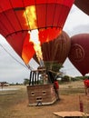 Bagan, Myanmar - November 5, 2019: Men lighting up burner in hot air baloon preparing to fly over the temples of Bagan