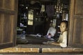 Bagan/Myanmar-October 5th 2019: An elderly Burmese woman is sitting by the window of the house