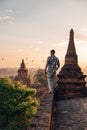 Bagan Myanmar young men watching Sunrise from the roof top of an ancient temple, man sunset roof pagoda temple Bagan