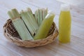 Bagasse after squeezing for a drink in basket and bottles of fresh sugar cane juice. Royalty Free Stock Photo