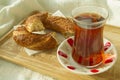 Bagel and cup of turkish tea on the wood tray with Istanbul pict