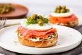 bagel half topped with lox, capers, and fresh dill