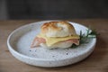 Bagel ham cheese in close up on wooden table in coffee shop Royalty Free Stock Photo