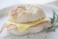 Bagel ham cheese in close up on wooden table in coffee shop Royalty Free Stock Photo