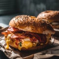Bagel sandwich with bacon, egg and cheese on dark background