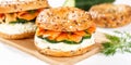 Bagel sandwich with salmon and cream cheese for breakfast on a kitchen board panorama Royalty Free Stock Photo