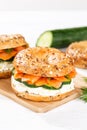 Bagel sandwich with salmon and cream cheese for breakfast on a kitchen board portrait format Royalty Free Stock Photo