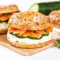 Bagel sandwich with salmon and cream cheese for breakfast on a kitchen board square Royalty Free Stock Photo