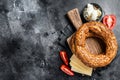 Bagel Simit or Gevrek on wooden board for cooking sandwich. Black background. Top view. Copy space Royalty Free Stock Photo