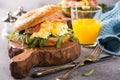 Bagels with scrambled eggs, rucola and fried bacon Royalty Free Stock Photo