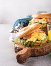 Bagels with scrambled eggs, rucola and fried bacon Royalty Free Stock Photo