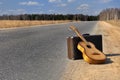 Baggage and guitar on empty road