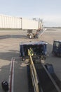 Baggage Handler Loading Luggage onto Airplane